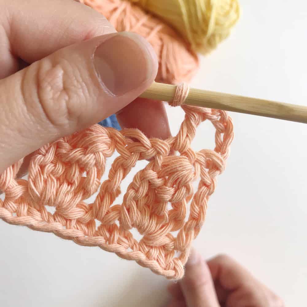 Learn to crochet the cluster stitch. Free crochet tutorial by Hannah Cross. Free crochet baby blanket pattern.