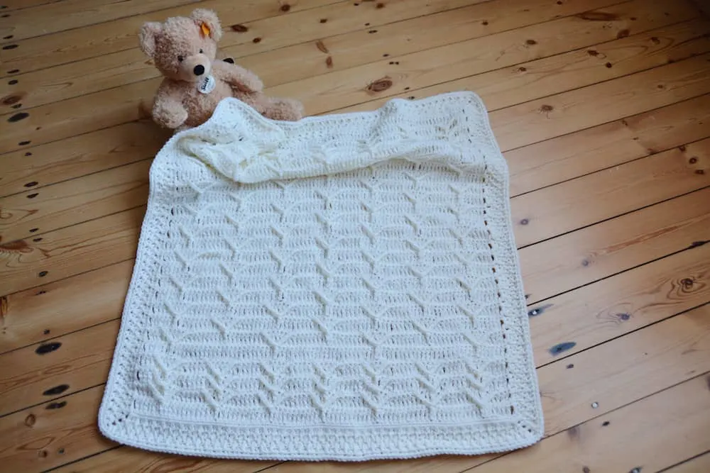 Cleo's Cloud Blanket a free crochet blanket pattern by Hannah Cross HanJan Crochet. Learn to crochet an heirloom baby blanket. Cream plain baby crochet blanket.