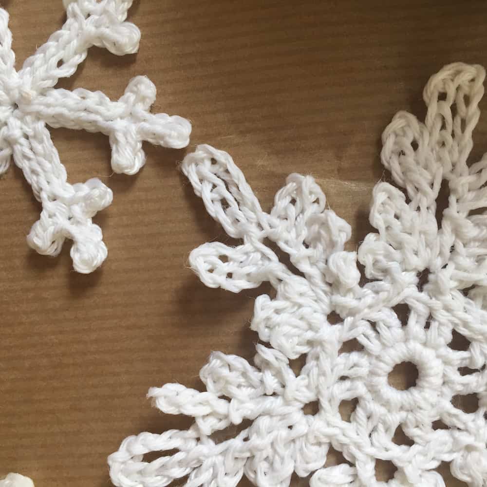 Close-up of white crocheted snowflakes.