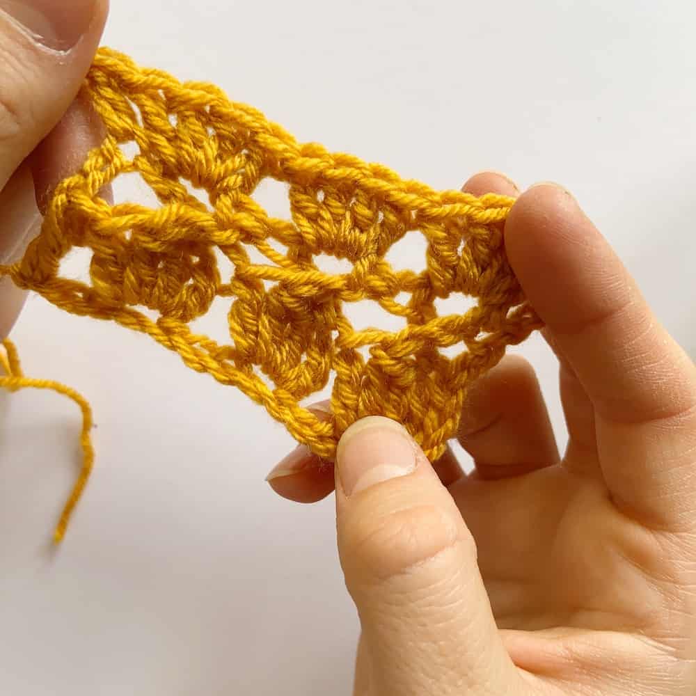 Learn to crochet the Cabbage Stitch with HanJan Crochet. A free step by step photograph tutorial to learn to crochet for beginners. The post also includes information about the free Oolong Blanket free crochet pattern by Hannah Cross.