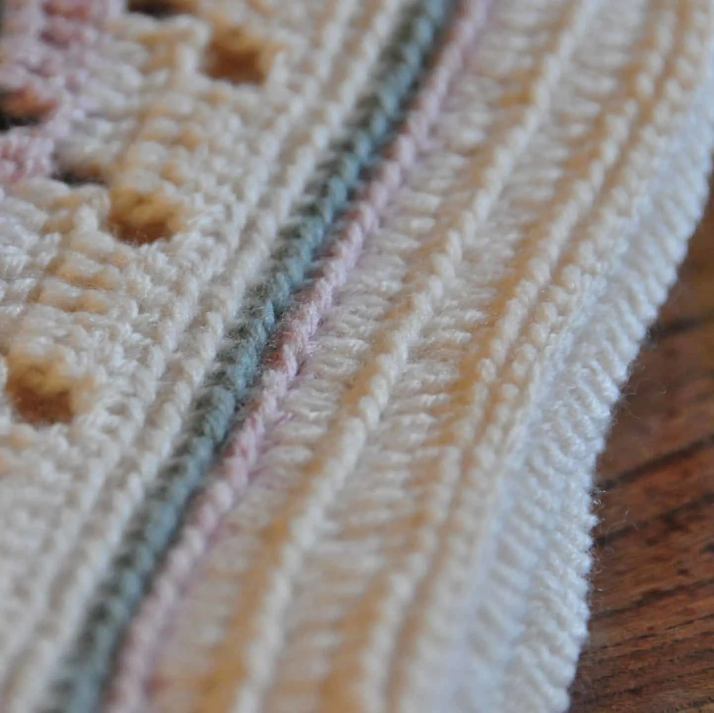 Learn to crochet this soft and subtle baby blanket as the perfect gift for a new arrival. Including a free crochet pattern and stitch tutorial anyone, even beginners, can master this filet crochet technique.