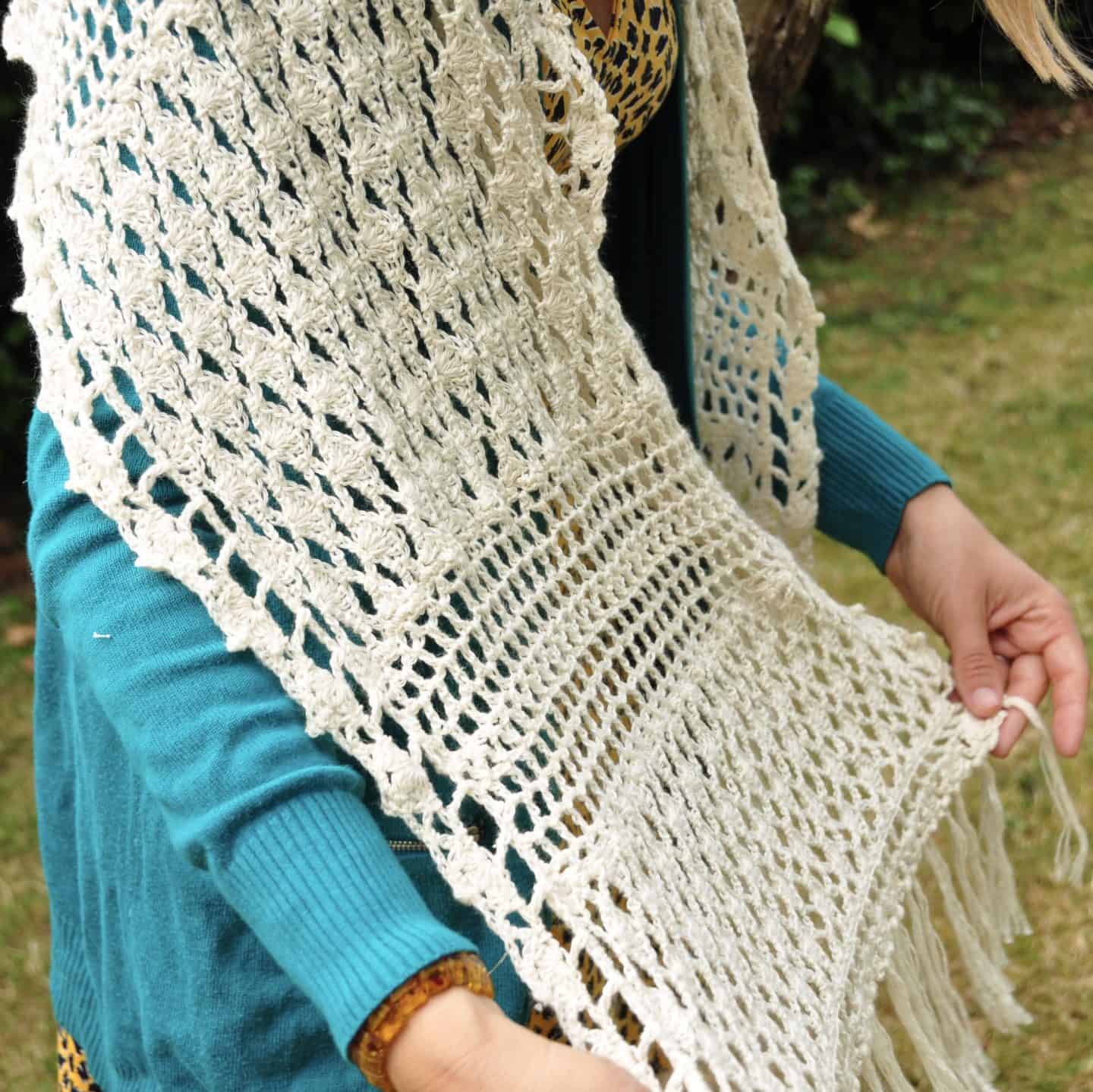 Learn to crochet this exquisite lace crochet shawl with a free crochet pattern and step by step crochet lace shell stitch tutorial. The rectangular shawl in made from 5 shell stitch panels joined by filet crochet sections and completed with a simple and delicate fringe. A beautiful wedding, confirmation or baptism shawl.