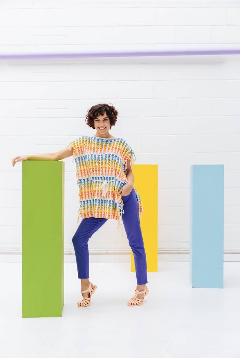 The Skittles Poncho, a bright and fun beginners crochet pattern by Hannah Cross of HanJan Crochet. A free crochet pattern to learn how to crochet in rainbow colours, a fun and easy summer make for you handmade wardrobe.