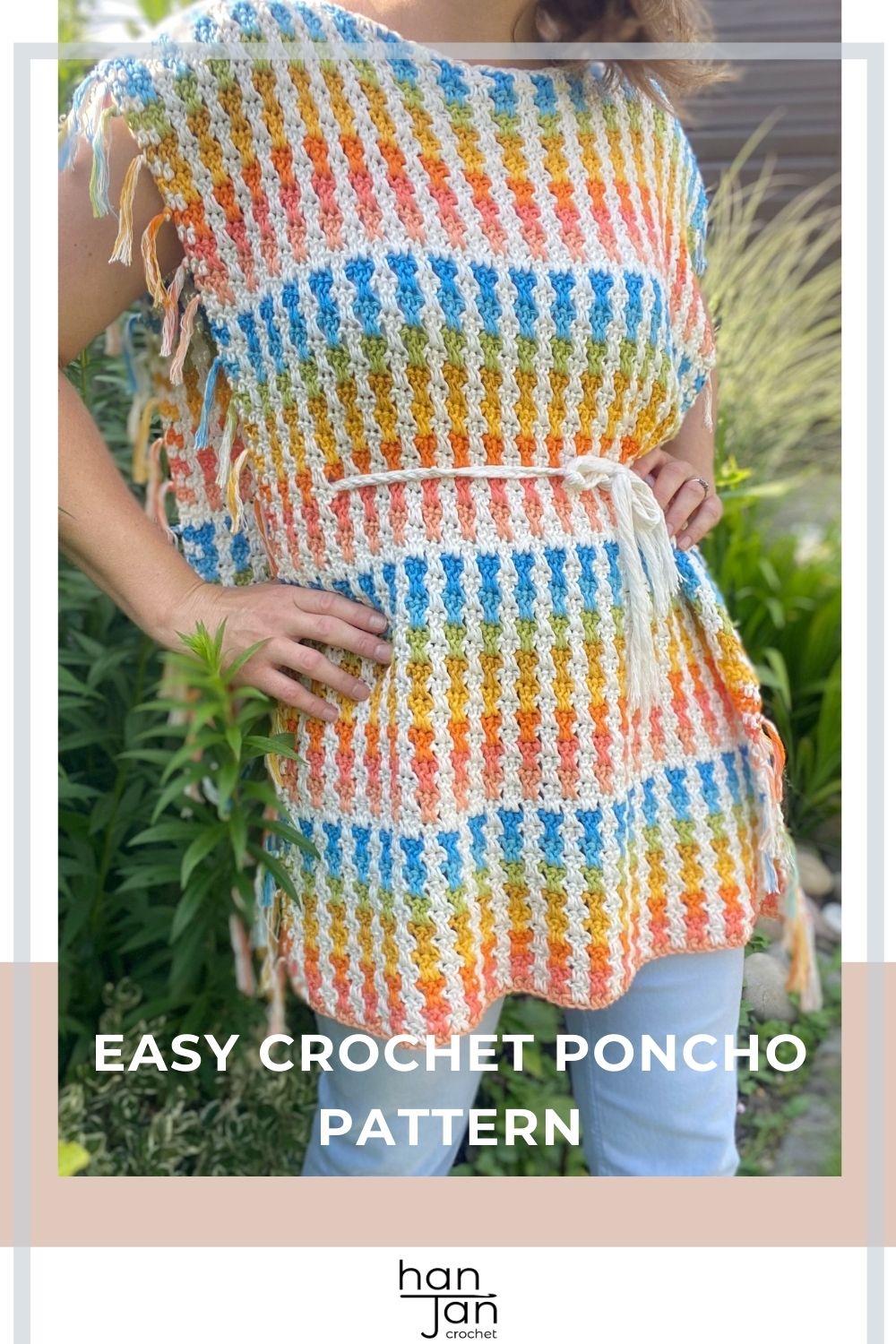 Person wearing a colorful summer crochet poncho with vertical stripes and a belt, standing outdoors. Text reads "Easy Crochet Poncho Pattern.