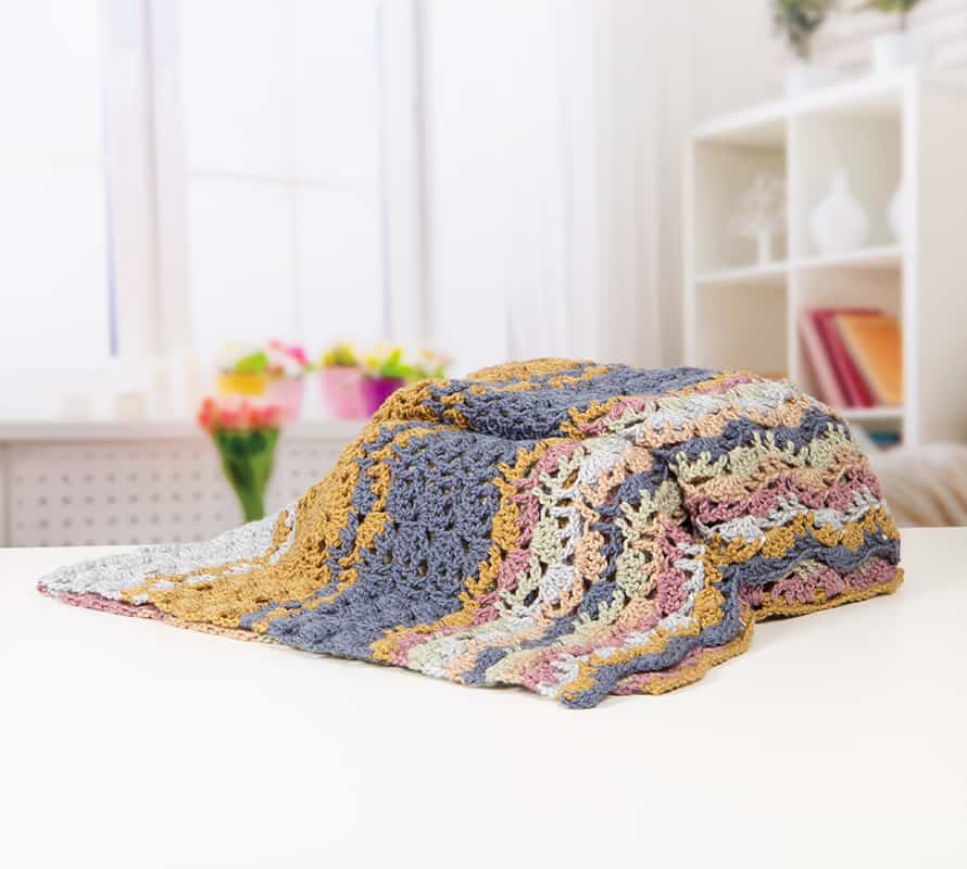 Learn to crochet this beautiful Lacy Wave crochet stitch with Hannah Cross of HanJan Crochet. Learn with step by step images and pattern to create a delicate and light lace crochet stitch. 