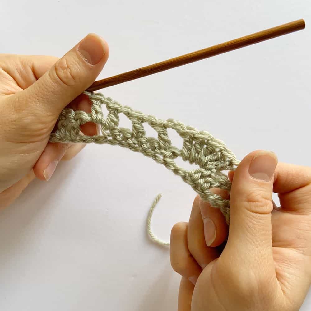 Learn to crochet this beautiful Lacy Wave crochet stitch with Hannah Cross of HanJan Crochet. Learn with step by step images and pattern to create a delicate and light lace crochet stitch. 