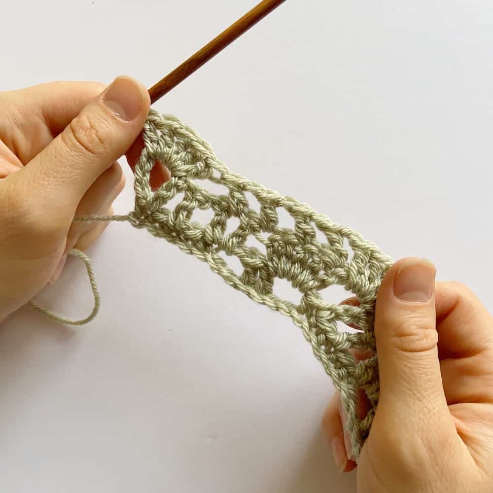 Learn to crochet this beautiful Lacy Wave crochet stitch with Hannah Cross of HanJan Crochet. Learn with step by step images and pattern to create a delicate and light lace crochet stitch. 