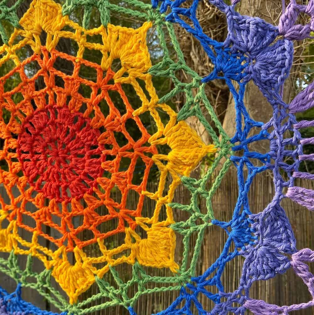 close up of rainbow mandala hanging in the garden