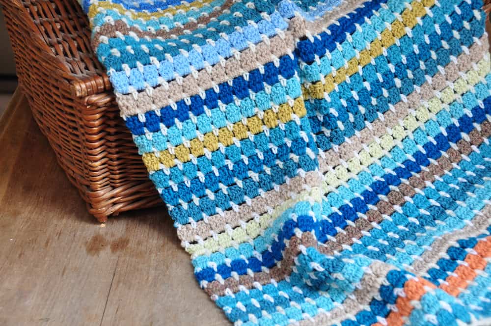 Learn to crochet six different free beginner crochet blanket patterns. Get advice on where to start, what crochet hooks and yarn you need and learn the V stitch, ripple stitch, granny block stitch, larksfoot stitch, cabbage patch stitch and cable stitch in these easy crochet patterns and tutorials. 