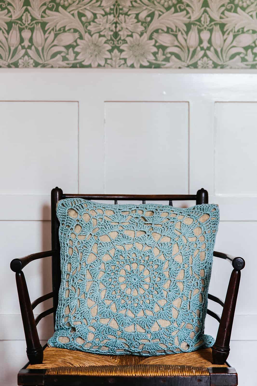 Beautiful lace crochet motif cushion on arts and crafts chair. Easy crochet home decor pattern.