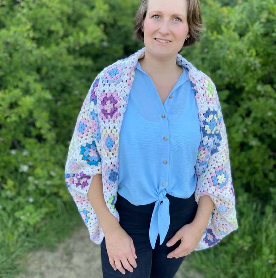 Woman wearing granny square crochet cardigan.