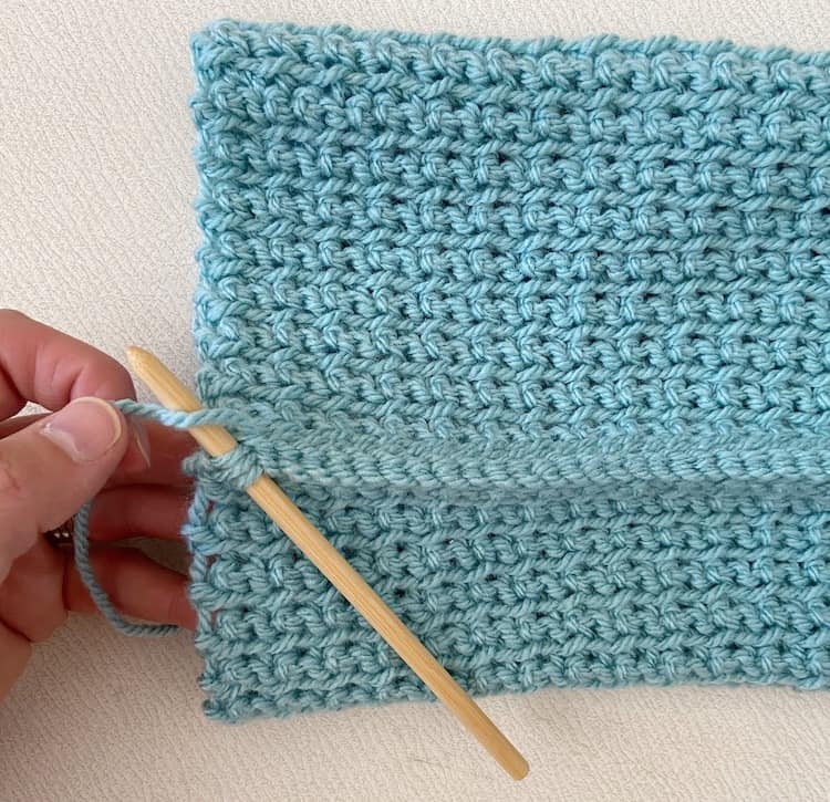 crochet hat being seamed together