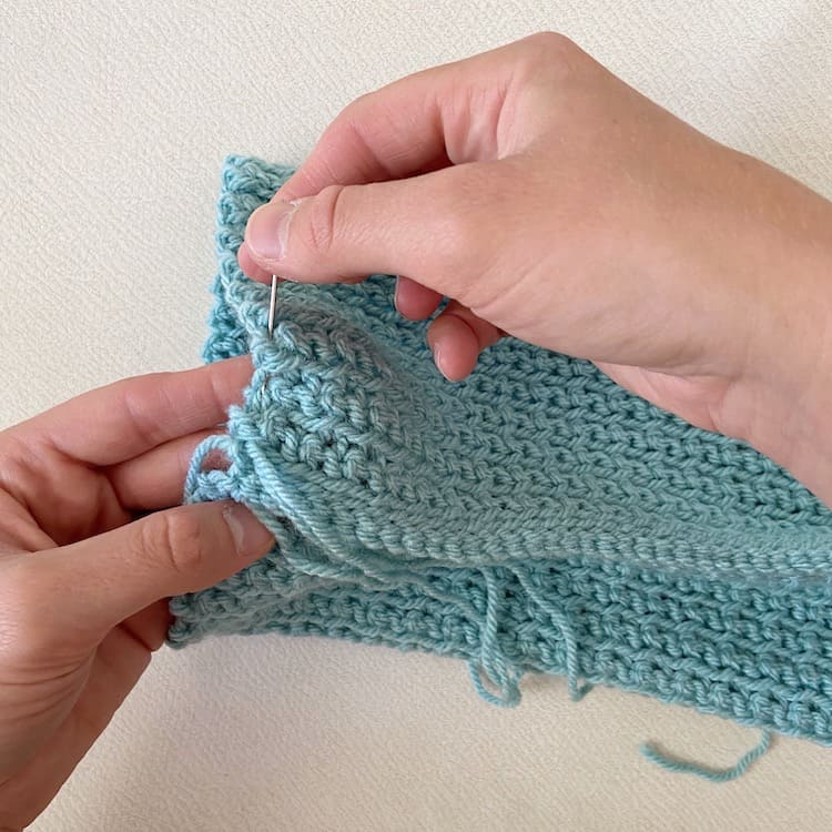 seaming a crochet beanie hat with sewing needle