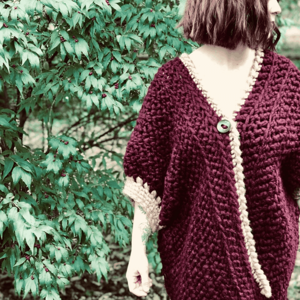 burgundy and cream cardigan on woman in woods