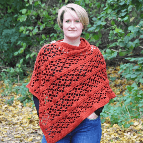 woman in woods wearing crochet orange poncho 