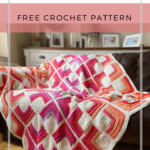 ombre crochet square motif blanket in bright colours laid on sofa