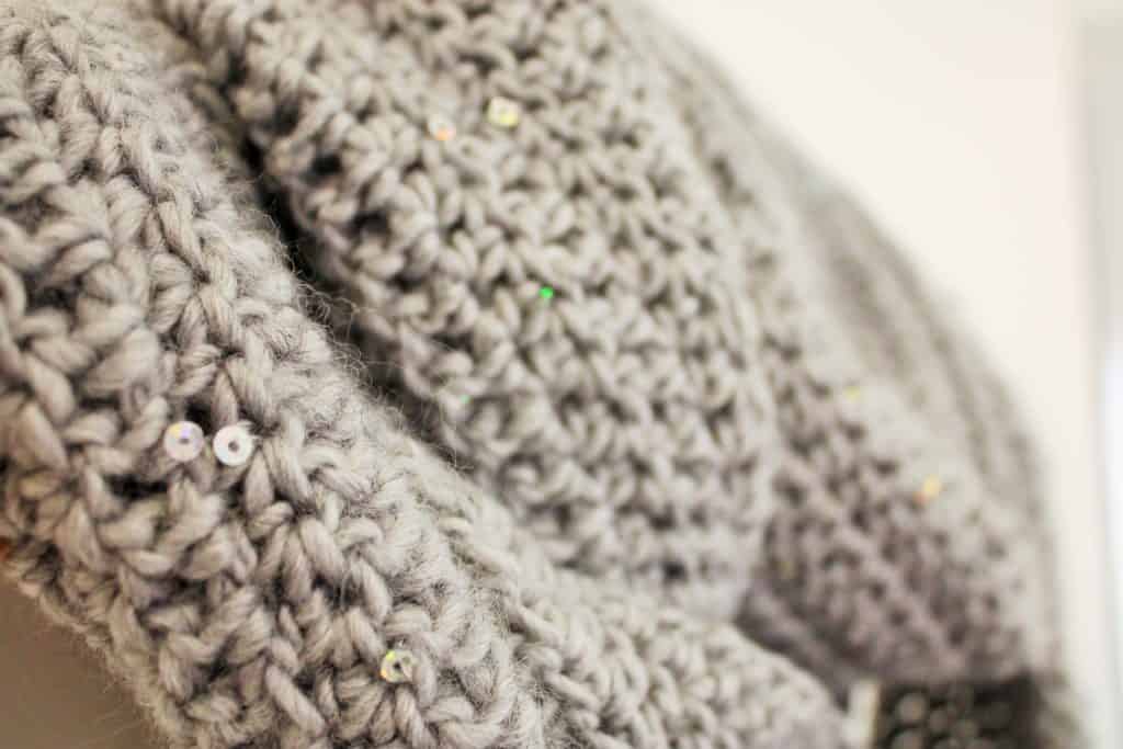 grey crochet scarf on hanger