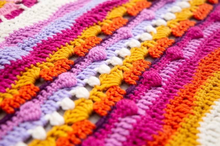 crochet bobble stitch close up in orange, pink and yellow