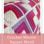 pink, purple, red and white crochet blanket on sofa