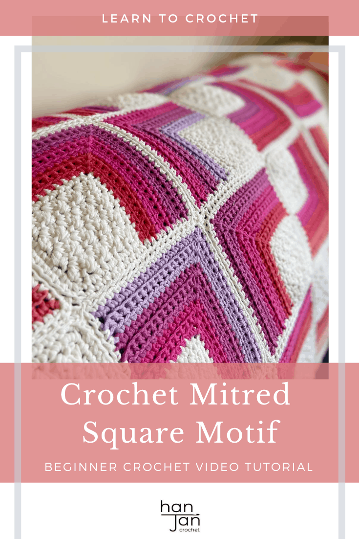 pink, purple, red and white crochet blanket on sofa
