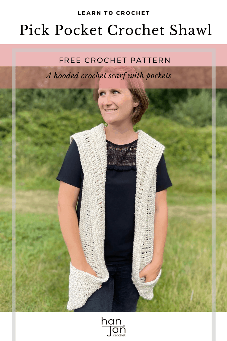 woman in field wearing black top and cream hooded crochet pocket shawl scarf