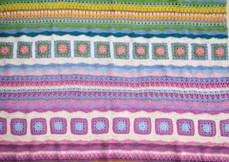 mindfulness crochet blanket, close up of pink, yellow, blue and green crochet squares and wave stitches 