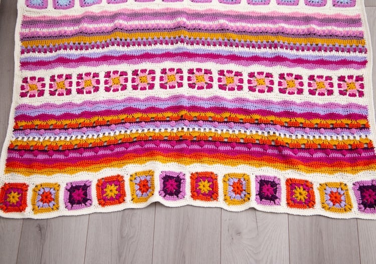 bottom of mindfulness crochet blanket in bright and uplifting colours laid on floor