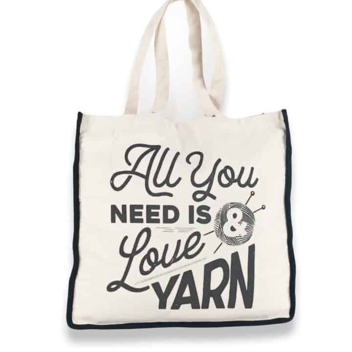 cream and black tote bag saying all you need is yarn