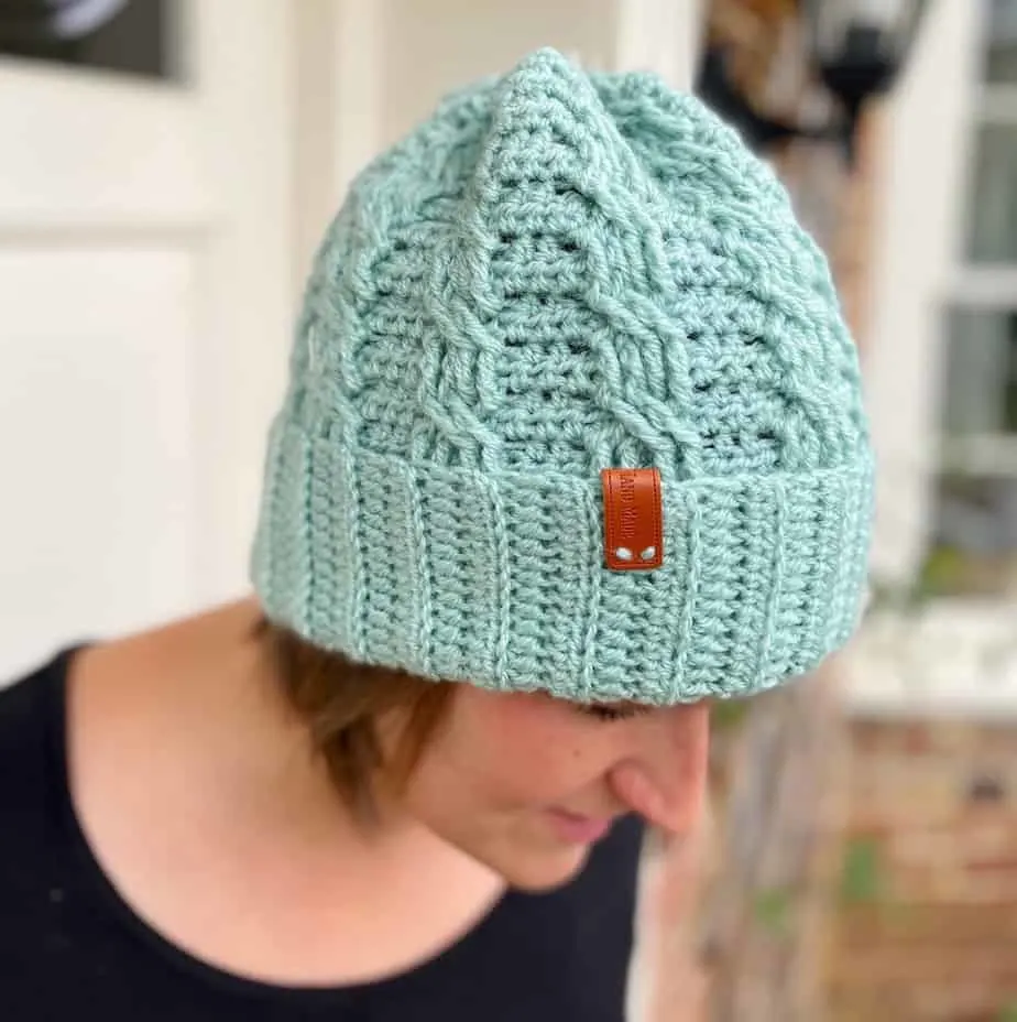 woman wearing mint green simple crochet cable hat, a winter beanie
