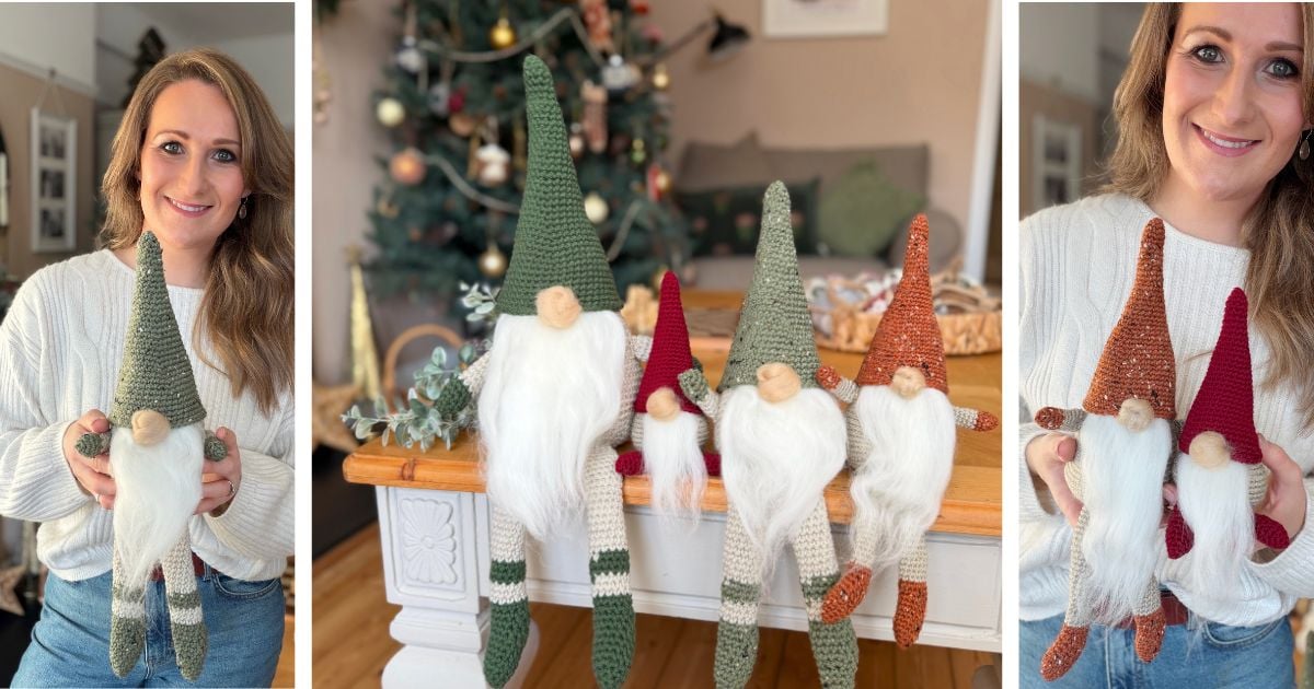 A woman holds handmade crocheted gnome dolls with long white beards, created using a free crochet gnome pattern; more gnomes are displayed on a table in front of a decorated Christmas tree.