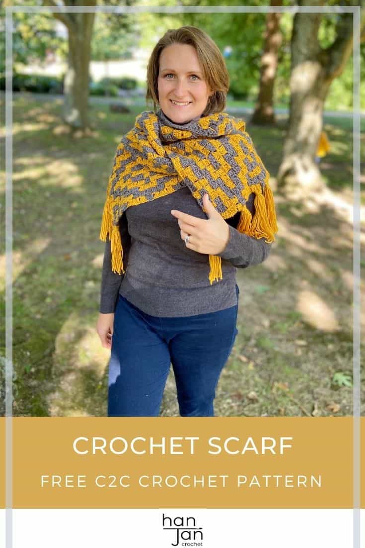 woman standing under tree wearing grey and yellow c2c crochet scarf