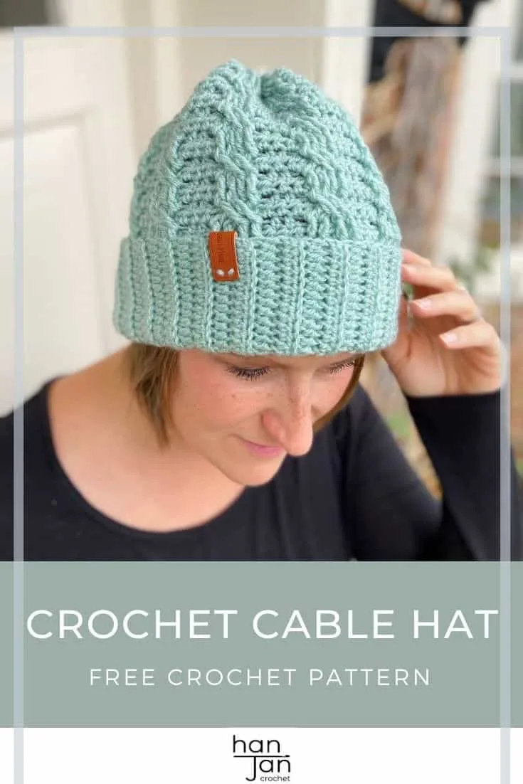 Woman wearing mint green simple crochet cable hat, a winter beanie.