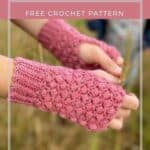 close up of hands wearing pink puff stitch crochet fingerless mittens