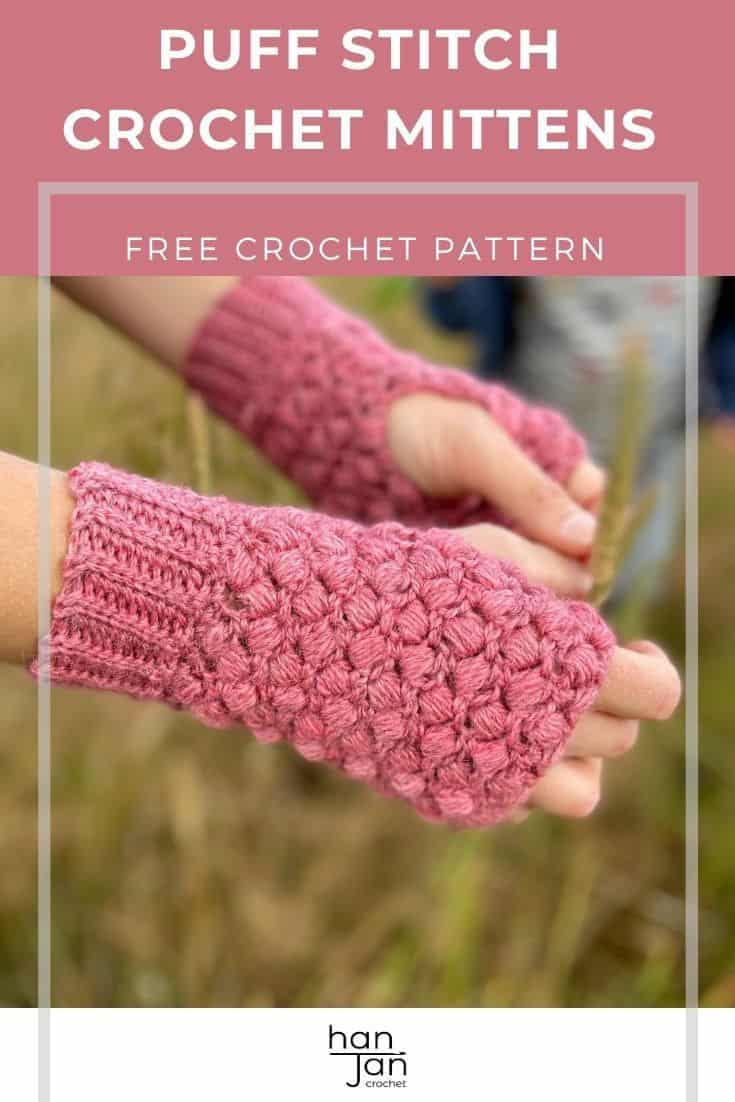 close up of hands wearing pink puff stitch crochet fingerless mittens