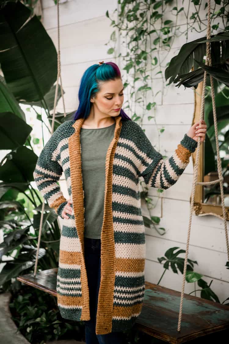 woman with blue hair wearing striped shortbread duster crochet cardigan 