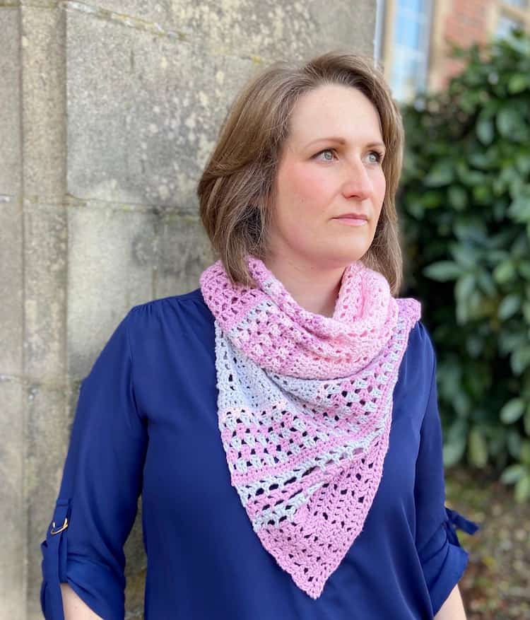 woman wearing pink and grey lace crochet shawl