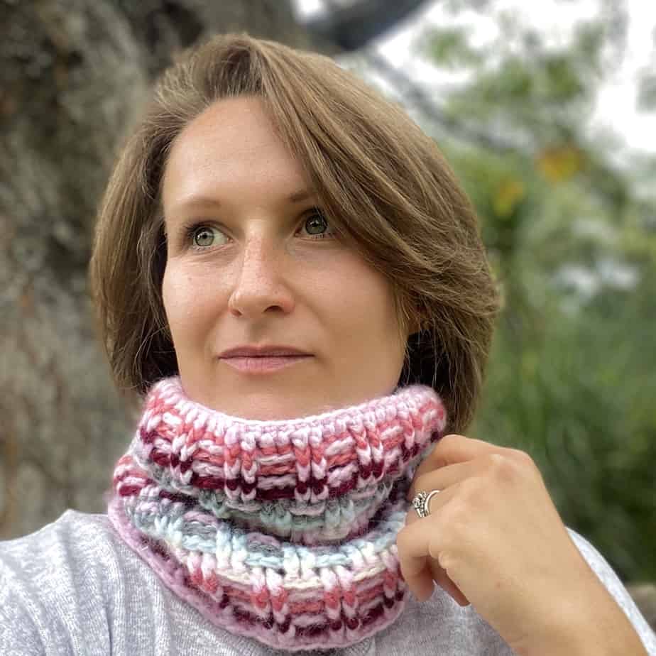 woman wearing rib stitch crochet cowl looking into the distance 