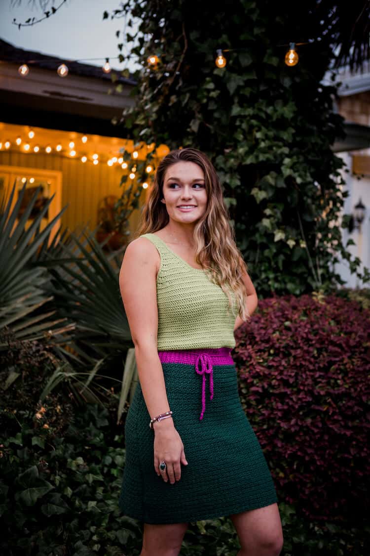 woman in garden with fairy lights wearing modern crochet dress