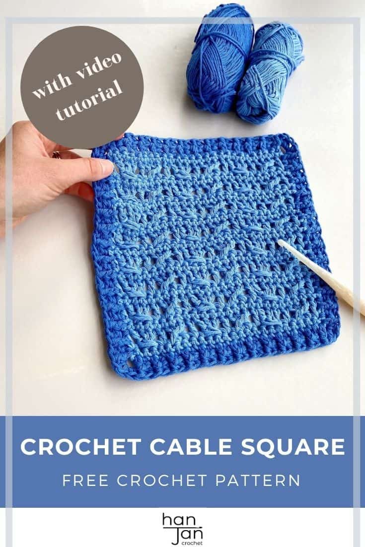 blue crochet cable square being held by hand on desk with blue yarn