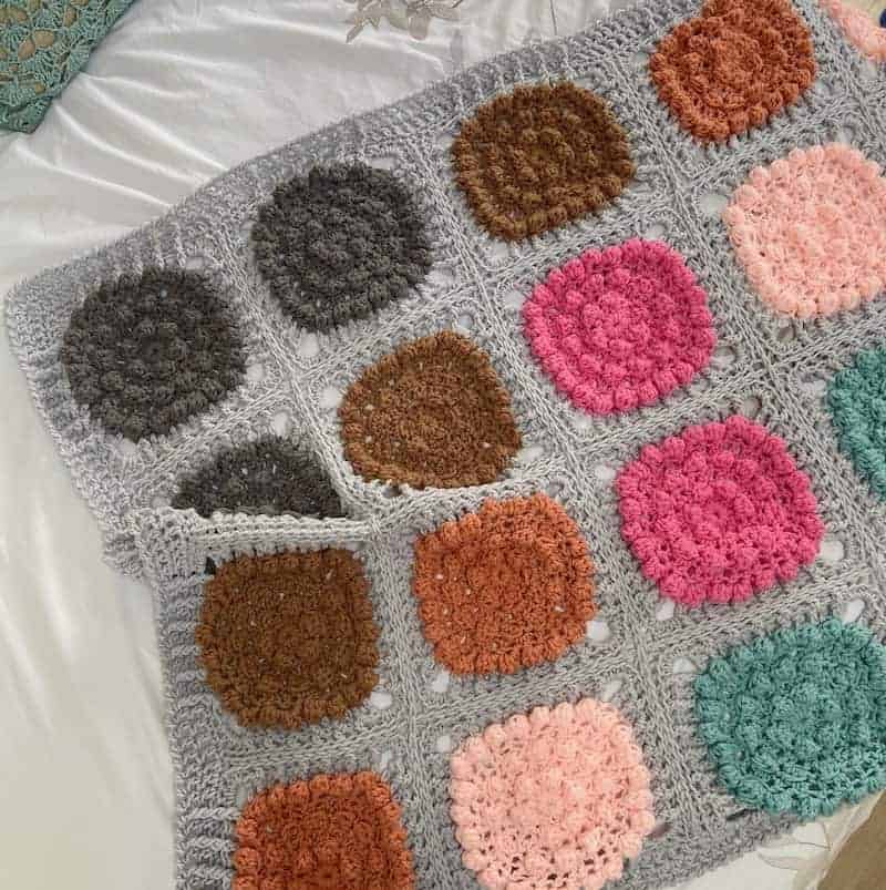Chunky bobble crochet blanket pattern in bright colours.