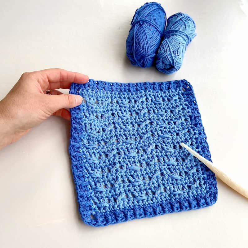 blue yarn and crochet cable stitch square