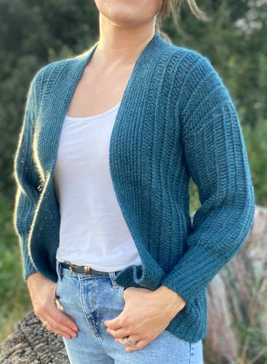 Woman in knit look crochet sweater pattern.