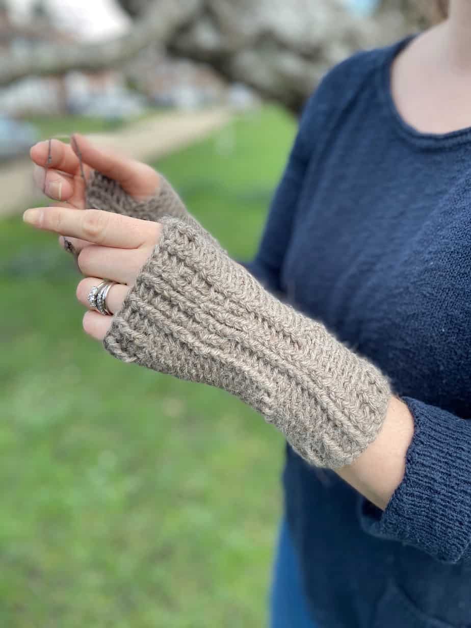 woman wearing fingerless crochet wool mitts in beige brown colour