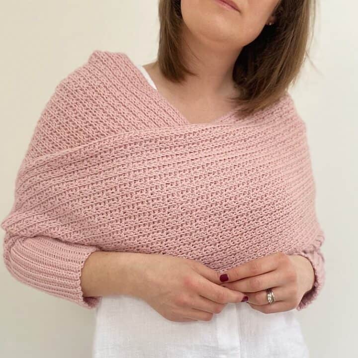 woman wearing pink Easy Scarf with Sleeves Crochet Pattern - The Eleanor Sweater Scarf