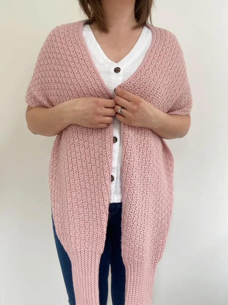 woman wearing pink crochet scarf draped around neck