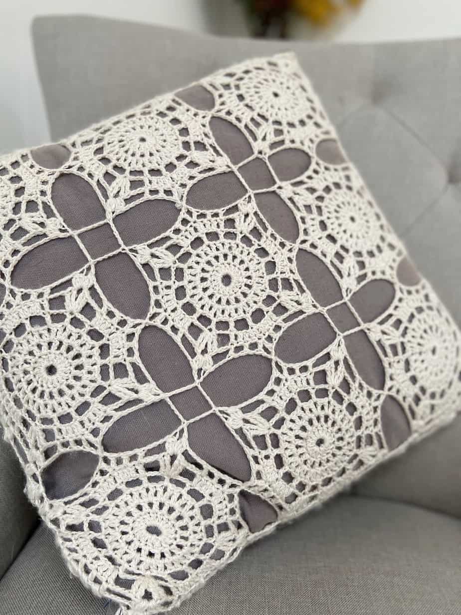 close up of white crochet lace motif pillow 