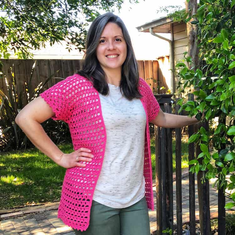 woman wearing bright pink lace crochet summer cardigan