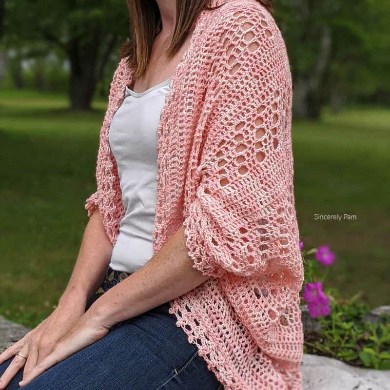 daphne crochet cocoon cardigan in pink on woman wearing jeans and vest top