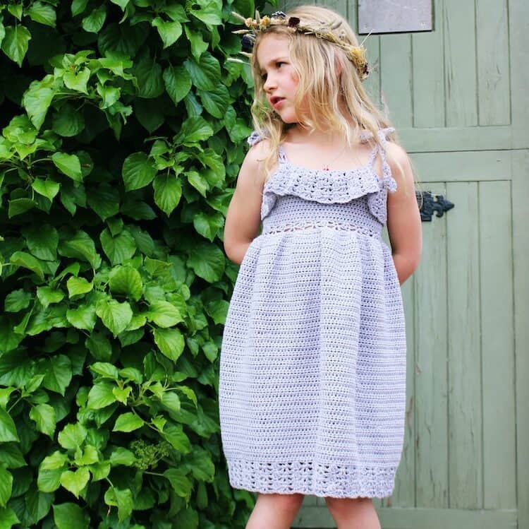 girl wearing lavender lace crochet dress with show string straps