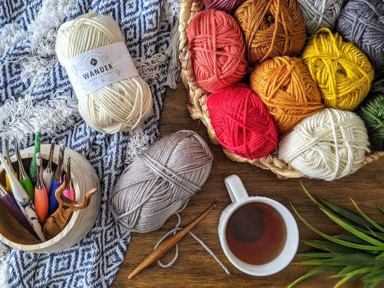 wander yarn by Furls in basket with blanket and crochet hooks